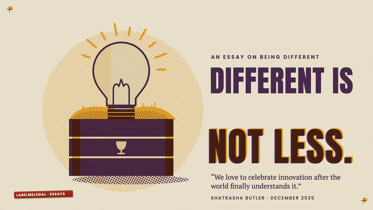 A lit lightbulb packed in straw inside an open wooden crate marked with a fragile glass, printed in two inks beside the words Different is not less.