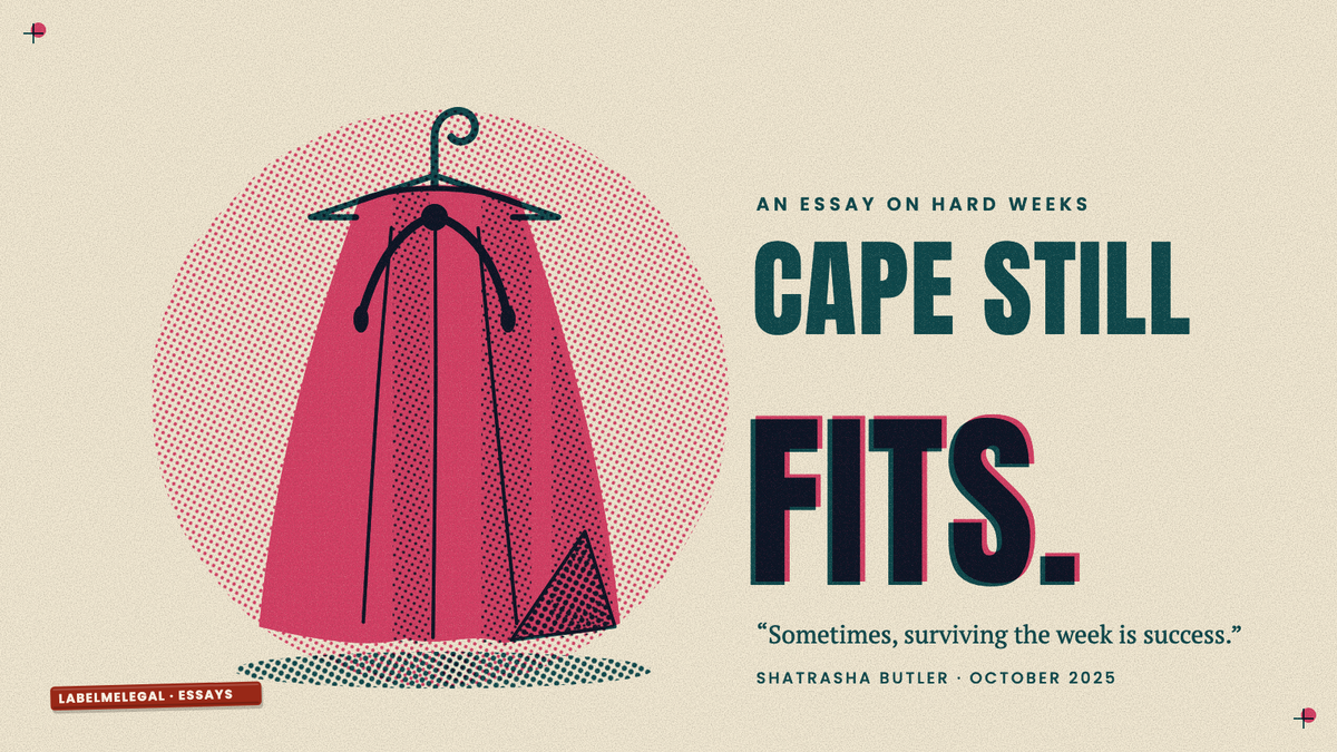 A pink hero's cape hanging creased on a wire hanger, its hem trailing on the floor, printed in two inks beside the words Cape still fits.